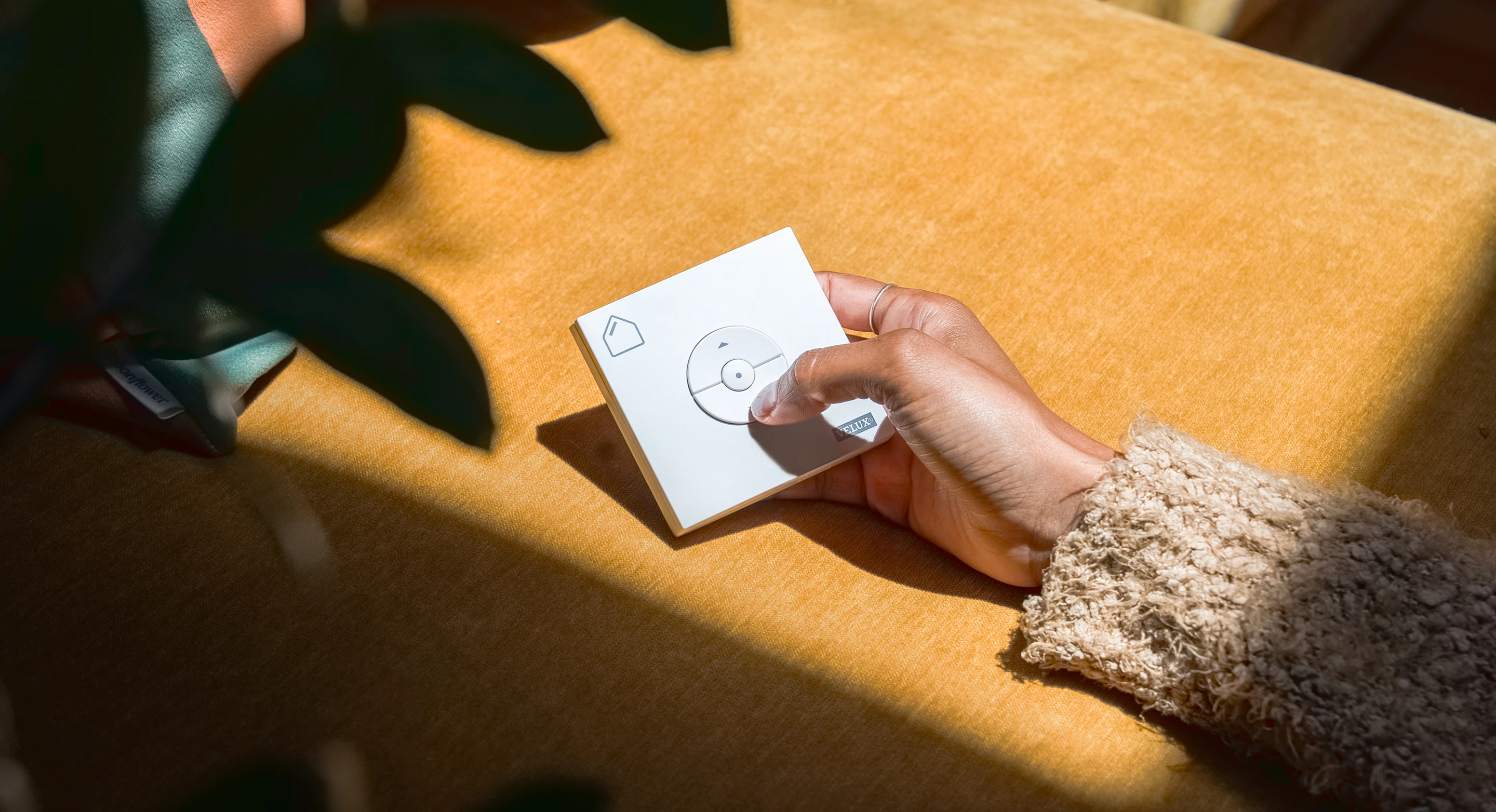 Hand holding VELUX remote for skylights