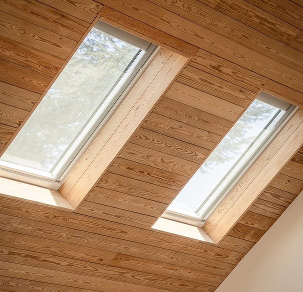 VELUX Skylight System lifestyle view — sunlit interior room with venting skylight open overhead