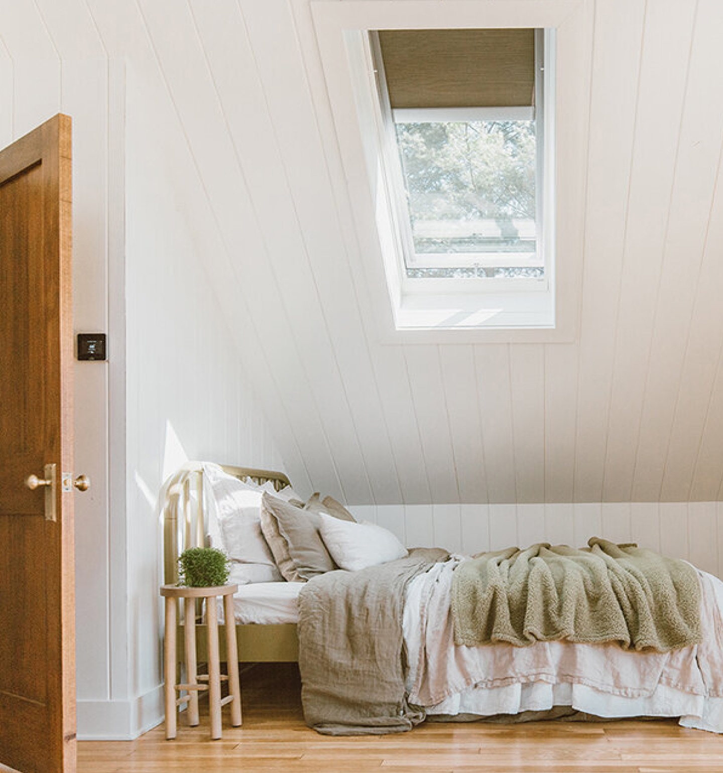 Photograph of bed placed under a skylight