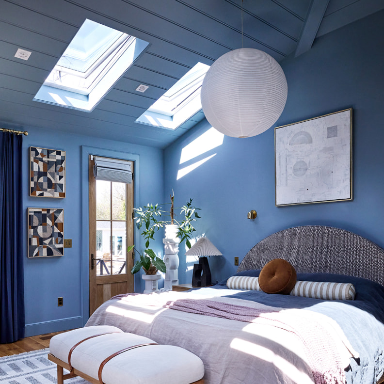 Bedroom interior after VELUX Skylight System installation — natural daylight from overhead skylight, bright airy space