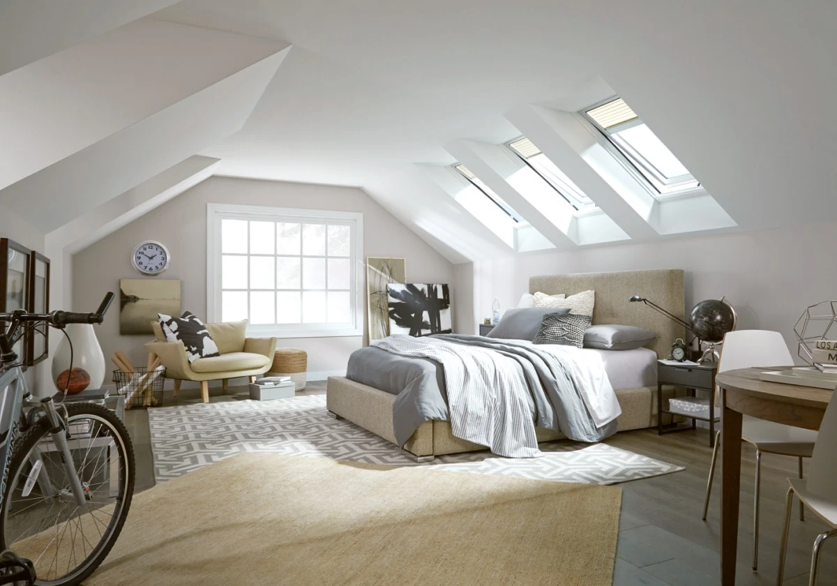 Bedroom interior after VELUX Skylight System installation — natural daylight from overhead skylight, bright airy space