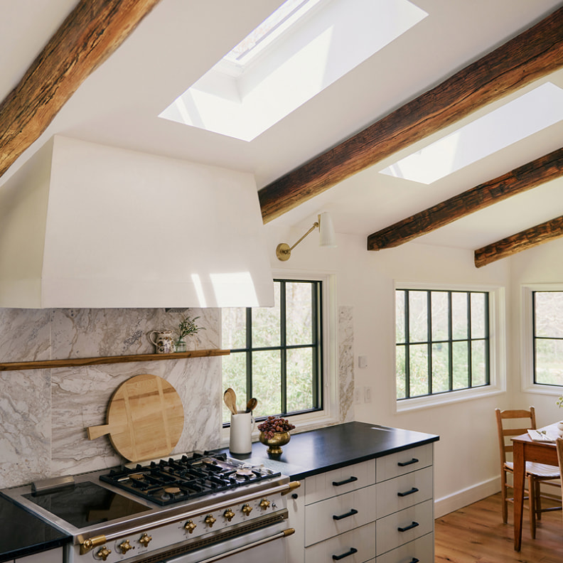Kitchen interior after VELUX Skylight System installation — bright natural daylight streaming through ceiling skylight