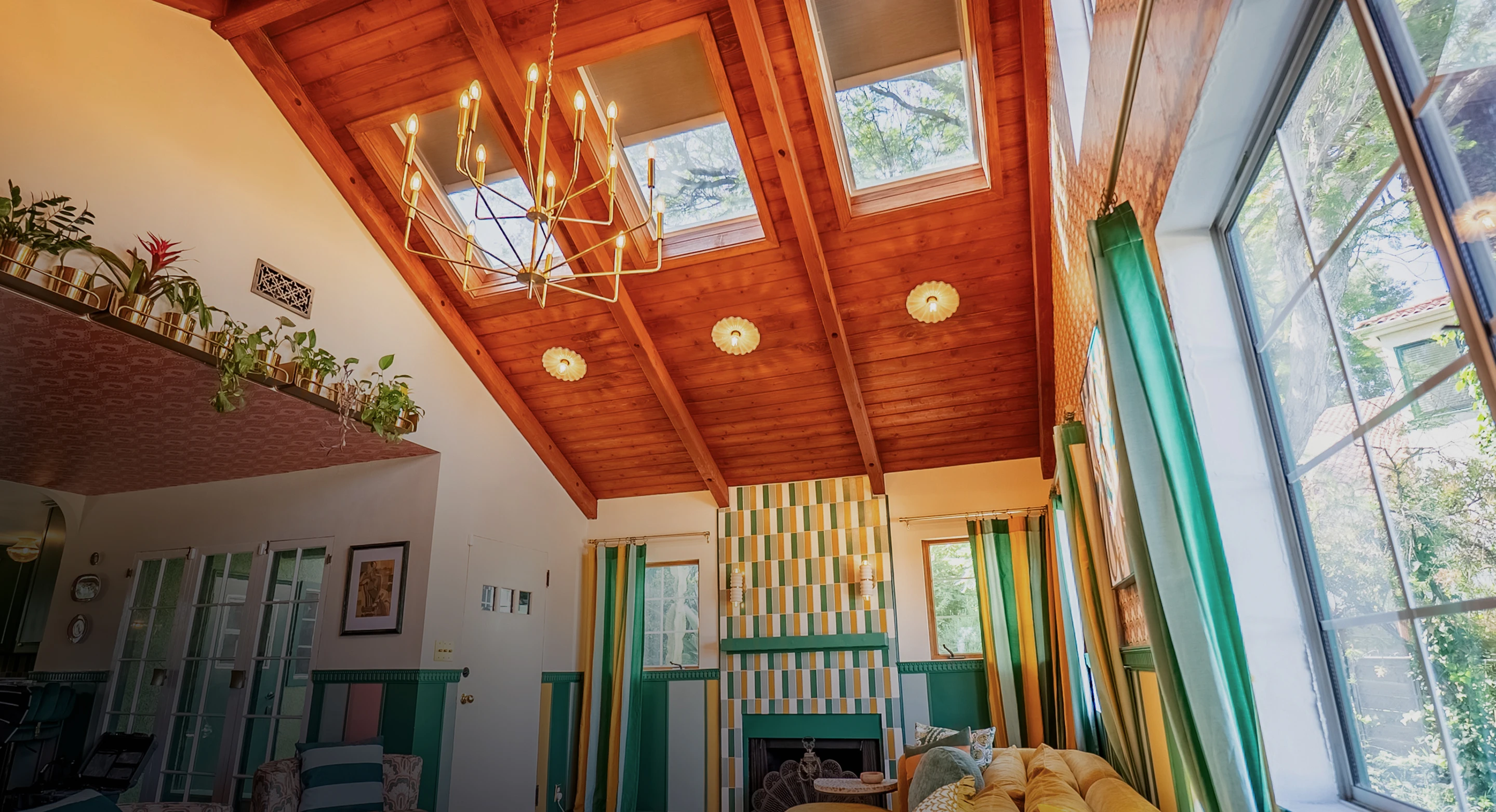 VELUX Skylight Systems installed in a sunlit living room ceiling — homeowner relaxing on couch beneath natural light.