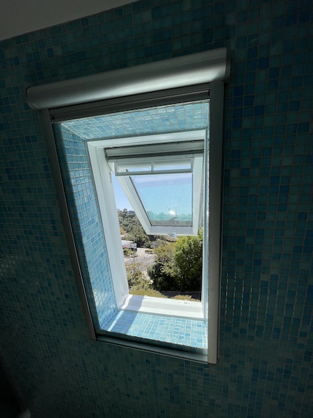 two skylights brighten a blue tonal bathroom
